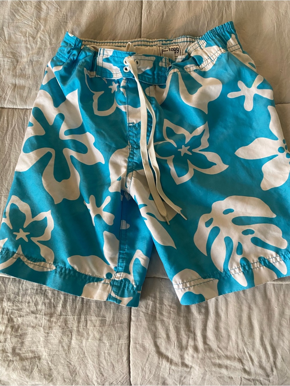 Place White Swim Trunks with Turquoise Stitching